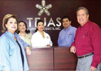 A group of people standing next to a desk

AI-generated content may be incorrect.