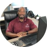 A person sitting at a desk with his arms crossed

AI-generated content may be incorrect.